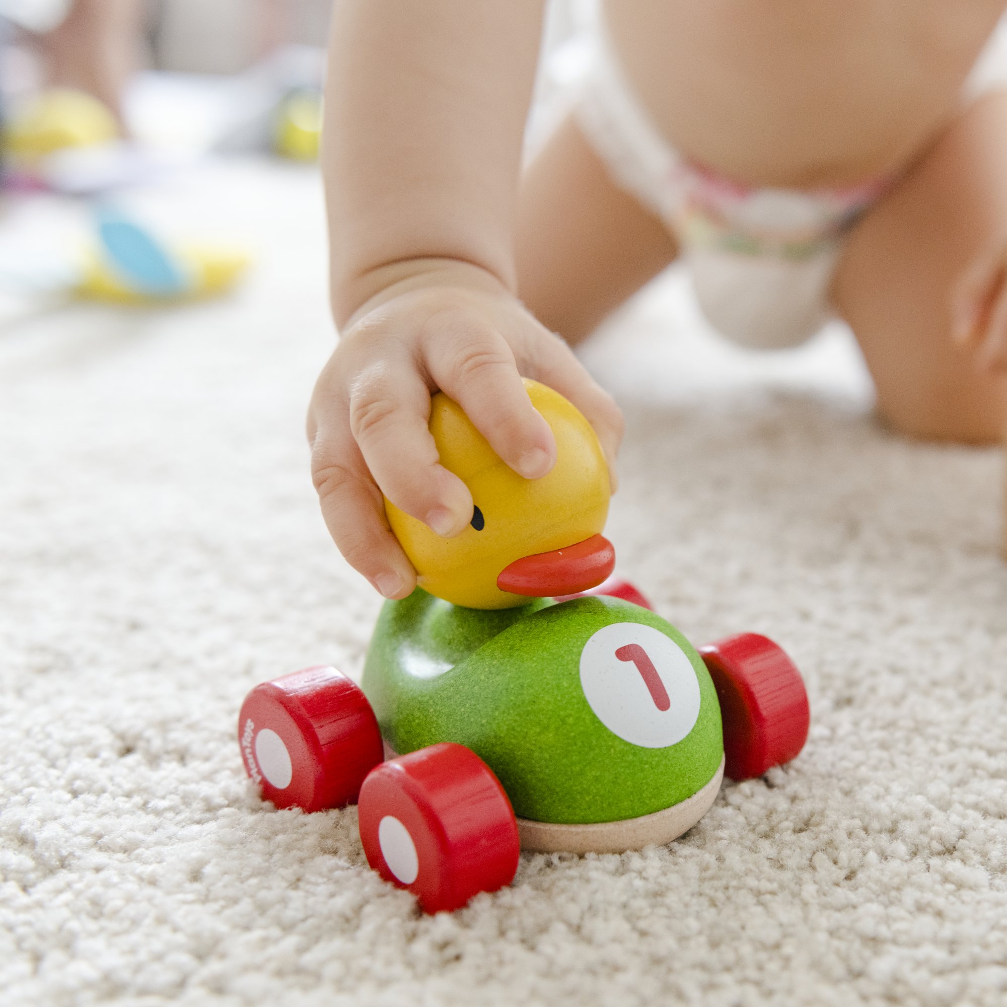 baby-playing-with-wooden-car