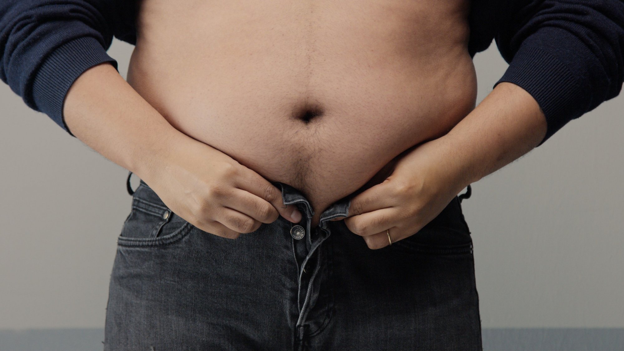 overweight-man-closeup-belly-side-view-put-up-shirt-pinch-clap-belly
